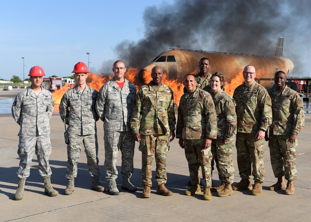 Chief Master Sergeant of the Air Force Kaleth O. Wright and his team pose for a photo with members of the 312th Training Squadron at the Louis F. Garland Department of Defense Fire Academy on Goodfellow Air Force Base, Texas, August 2, 2019. The 312th TRS displayed the accuracy of the simulations trainees face by allowing Chief Wright to use the water turret to douse a fire. (U.S. Air Force photo by Airman 1st Class Ethan Sherwood/Released)