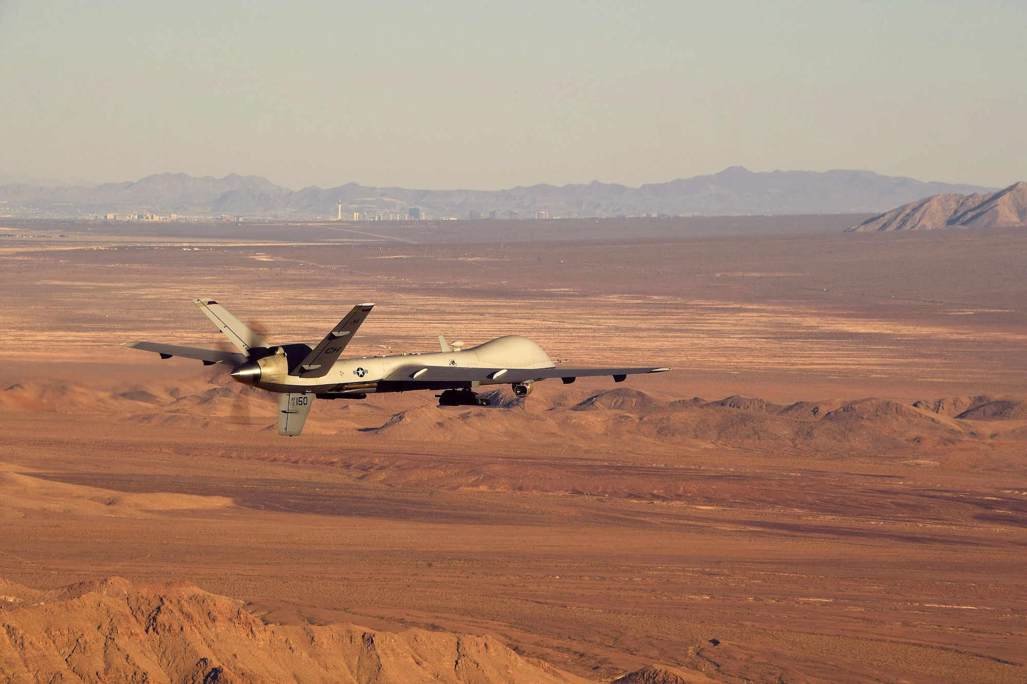 An MQ-9 Reaper flies a training mission over the Nevada Test and Training Range, July 15, 2019. The Reaper and its aircrew are considered one of the most demanded aircraft in combat operations due to its ability to provide oversight, gather intelligence and employ munitions on the battlefield for 18-20 hours at a time. (U.S. Air Force photo by Staff Sgt. James Thompson)