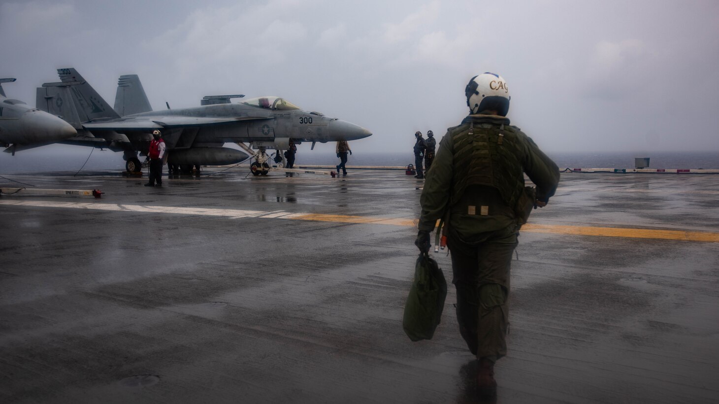 PHILIPPINE SEA (August 2, 2019) Capt. Forrest Young, Commander, Carrier Air Wing 5, walks toward his aircraft on the flight deck of the Navy’s forward-deployed aircraft carrier USS Ronald Reagan (CVN 76) prior to conducting an in-flight change of command ceremony. Young was relieved as commanding officer of Carrier Air Wing (CVW) 5 by Capt. Michael Rovenolt. Ronald Reagan, the flagship of Carrier Strike Group Five, provides a combat-ready force that protects and defends the collective maritime interests of its allies and partners in the Indo-Pacific region.