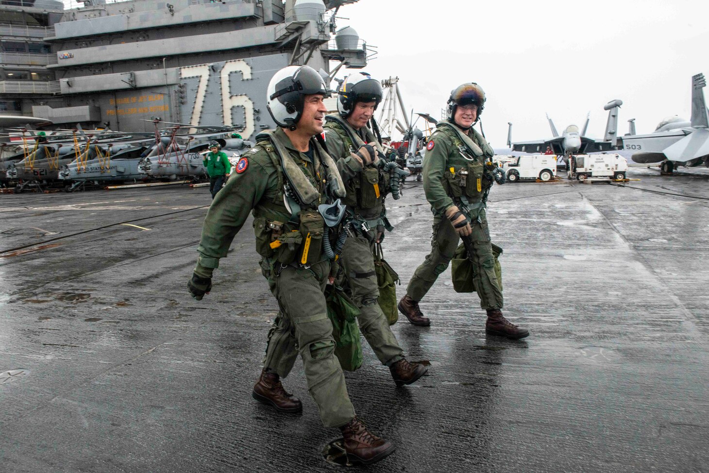 PHILIPPINE SEA (August 2, 2019) Capt. Forrest Young, left, and Capt. Michael Rovenolt, far right, Commander, Carrier Air Wing 5, walk away from their aircraft on the flight deck aboard the Navy’s forward-deployed aircraft carrier USS Ronald Reagan (CVN 76) after Carrier Air Wing 5’s (CVW 5) change of command ceremony. Young was relieved as commanding officer of Carrier Air Wing (CVW) 5 by Rovenolt. Ronald Reagan, the flagship of Carrier Strike Group 5, provides a combat-ready force that protects and defends the collective maritime interests of its allies and partners in the Indo-Pacific region.