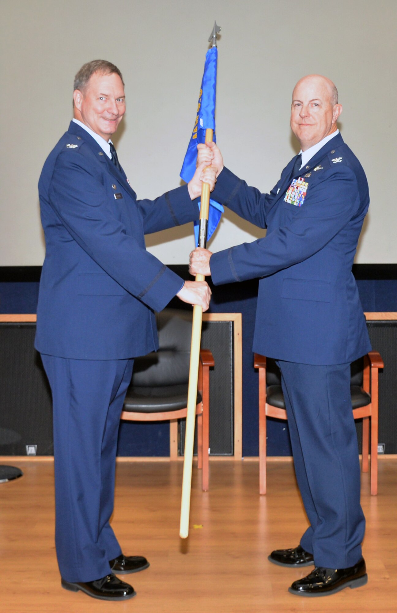Col. Terry W. McClain, 433rd Airlift Wing commander, presents the 433rd Operations Group guidon to Col. James C. “JC” Miller signifying his assumption of command at a ceremony Aug. 3, 2019 at Joint Base San Antonio-Lackland, Texas.