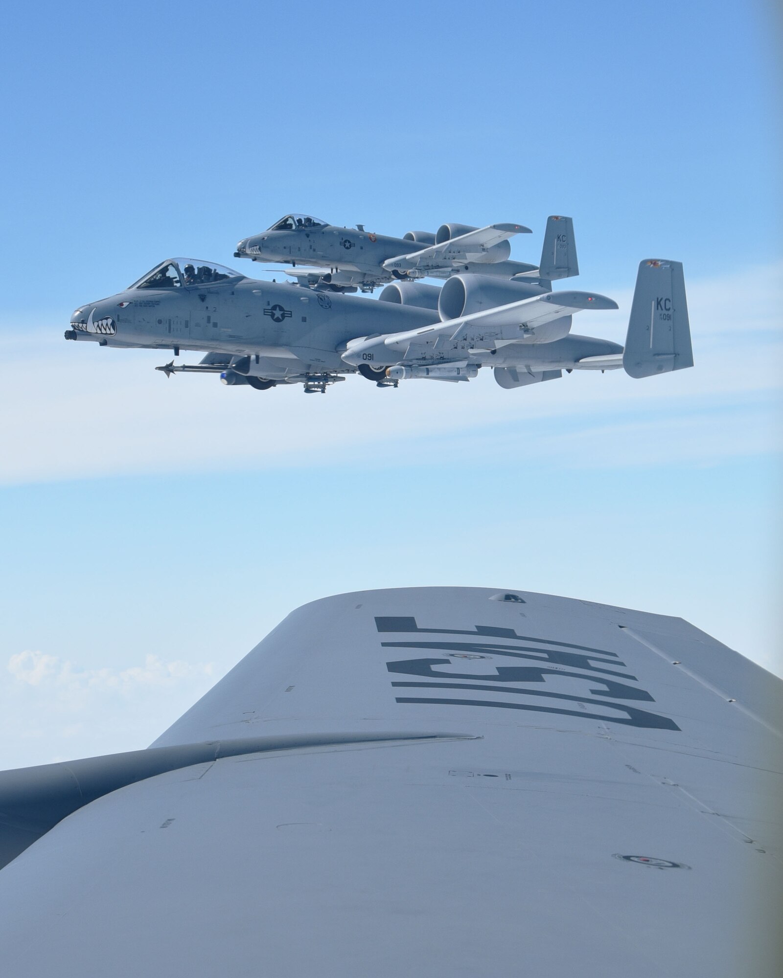 Two A-10 Thunderbolts from the 442nd Fighter Wing at Whiteman AFB, Mo., flys close to the wing of a KC-135 Stratotanker assigned to McConnell Air Force Base, Kan., during a "Bosslift" sponsored by the local Employer Support of the Guard and Reserve, Aug. 3, 2019.  During the flight, 11 civilian employers of 931st Air Refueling Wing Traditional Reservists observed the aerial refueling of the A-10s by a 931 ARW aircrew.