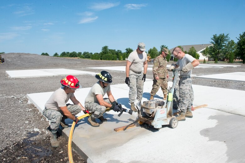 Senior Airmen Jeffery Peters, 434th Civil Engineer Squadron pest management journeyman, saws relief cuts in a concrete pad, at Grissom Air Reserve Base, Indiana Aug. 3, 2019. The training area will help accelerate readiness by providing realistic bivouacs training sites. (U.S. Air Force photo/Tech. Sgt. Jami K. Lancette)