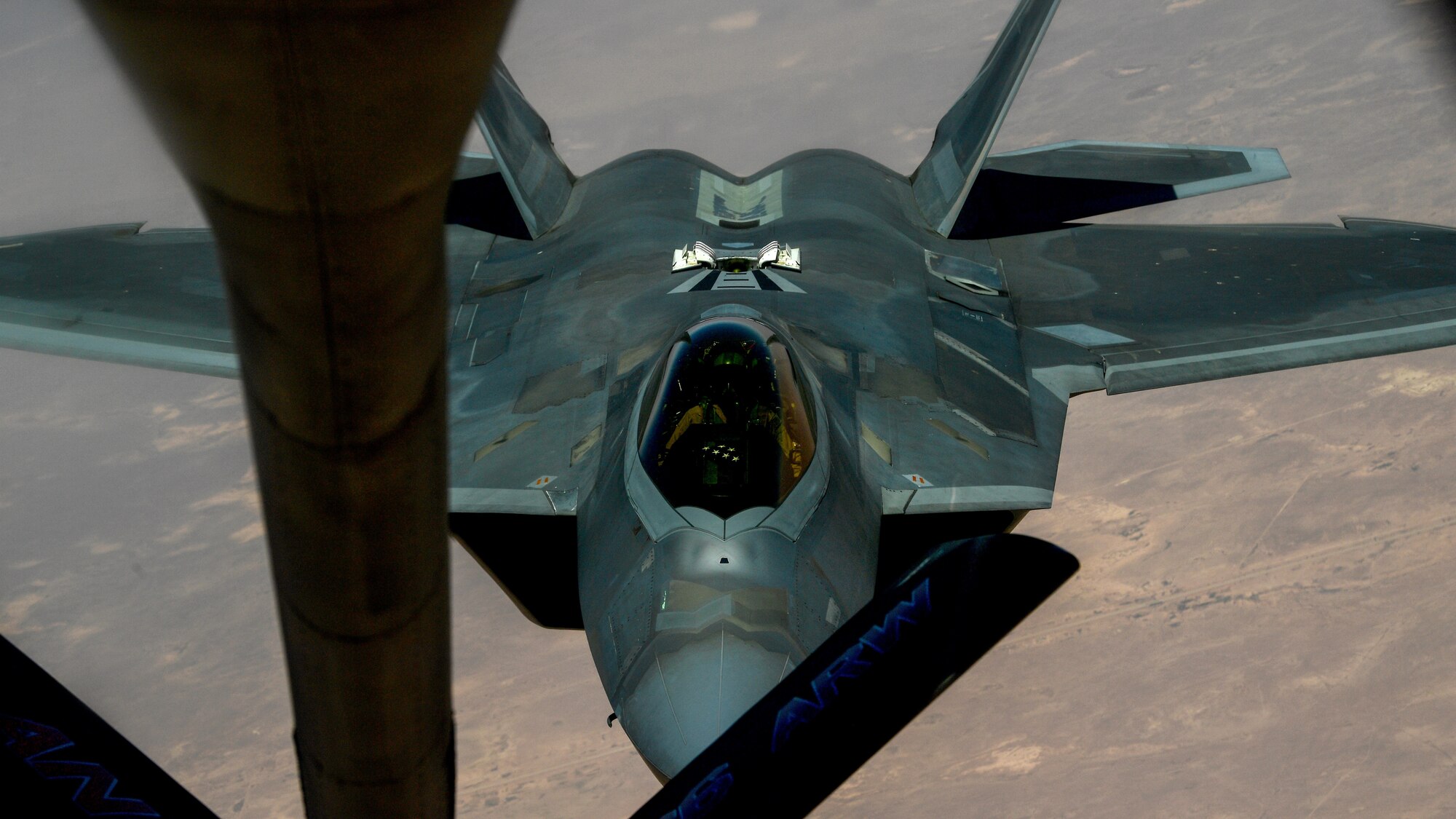 A photo of an F-22 moving in to receive fuel from a KC-135.