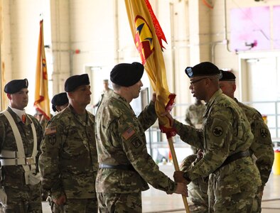 U.S. Army Reserve Command Deputy Commanding General, Maj. Gen. A.C. Roper, passes the 377th Theater Sustainment Command colors to Maj. Gen. Greg Mosser,  during a change of command ceremony at Naval Air Station Joint Reserve Base New Orleans, Belle Chasse, La.