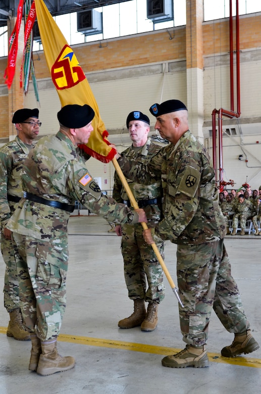 The 377th Theater Sustainment Command's senior enlisted leader, Command Sgt. Major Lawrence Arnold, passes the unit colors to outgoing commander, Maj. Gen. Steven Ainsworth during a change of command ceremony at Naval Air Station Joint Reserve Base New Orleans August 3, 2019.
