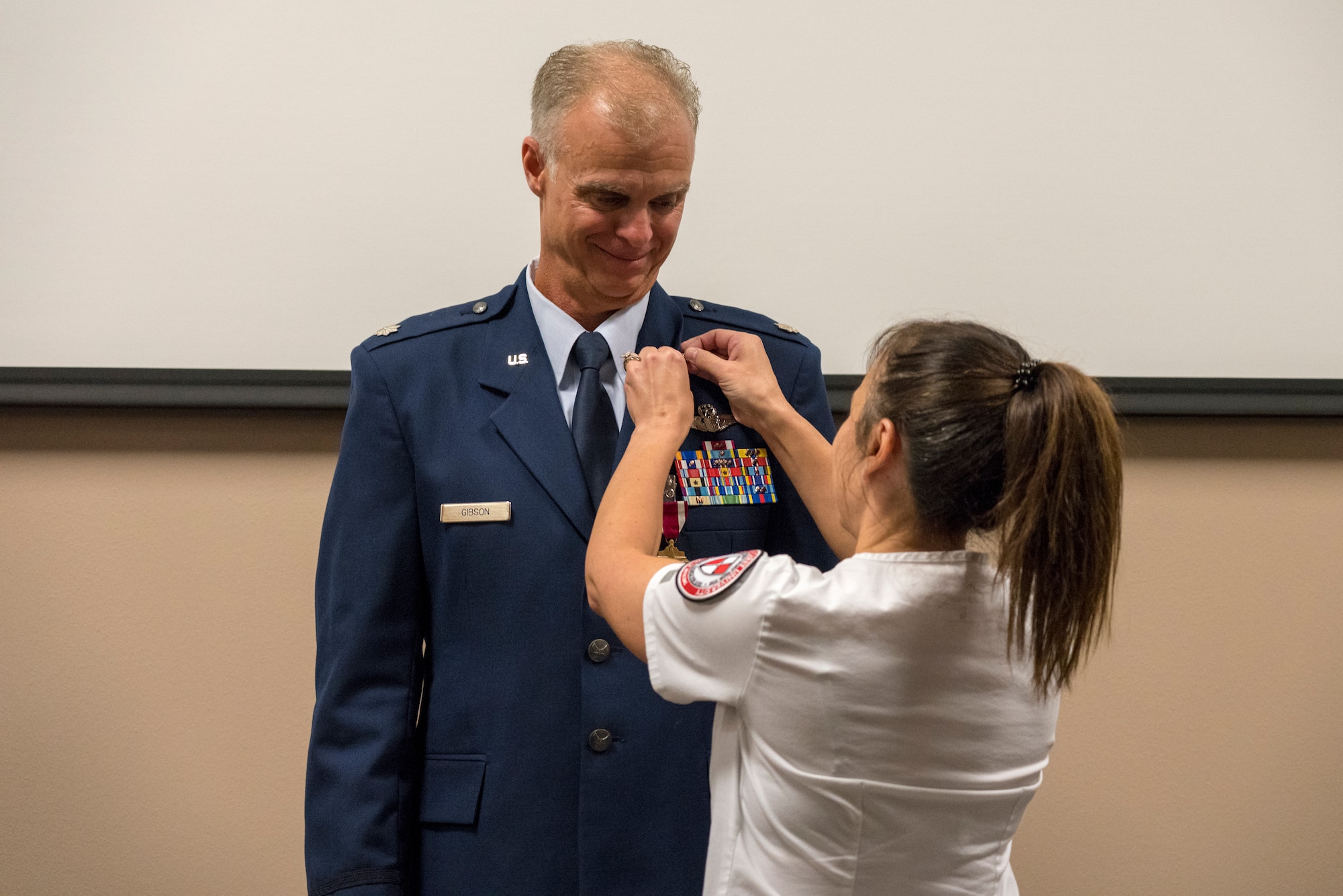 Shelly Gibson pins the U.S. Air Force retirement pin on her husband Lt. Col. Keith Gibson, 403rd Wing Operations Group deputy commander, during his retirement ceremony Aug. 3, 2019 at Keesler Air Force Base, Mississippi. Gibson completed his Air Force career with 29 years of service. (U.S. Air Force photo by Tech. Sgt. Christopher Carranza)