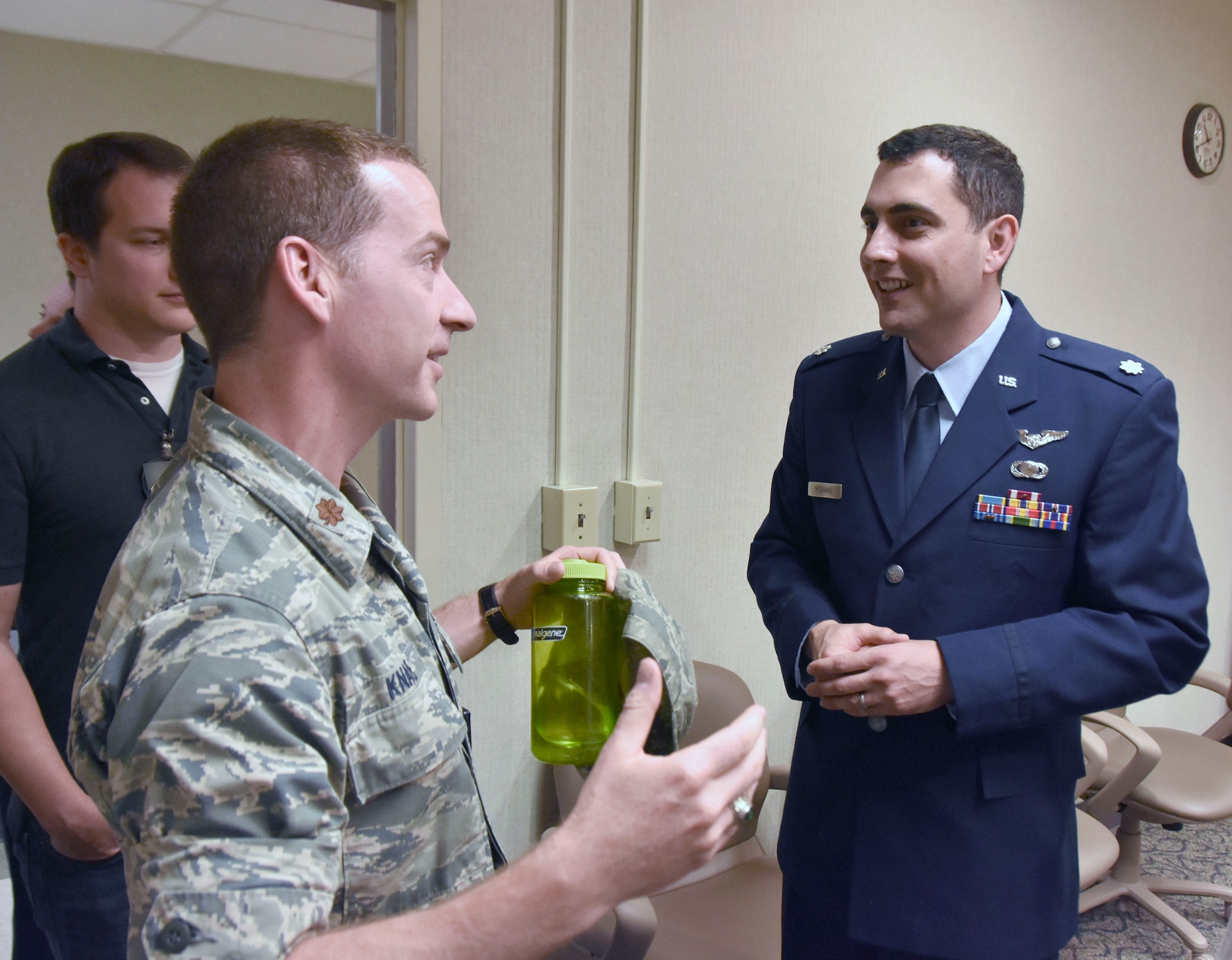 Following the Change of Leadership ceremony, AEDC Flight Systems Commander Lt. Col. John McShane, at right, is welcomed by Maj. Michael Knauf, AEDC Aeropropulsion Operations Officer, and other AEDC team members. (U.S. Air Force photo by Bradley Hicks) (This image has been altered by obscuring a badge for security purposes.)