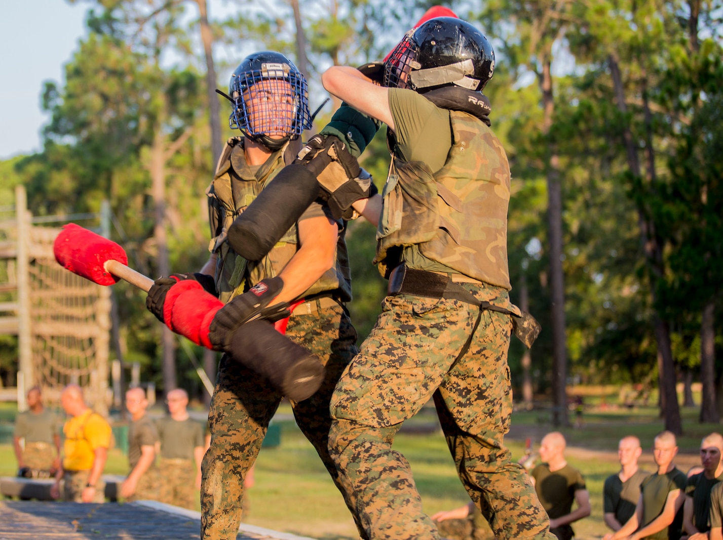 Recruits with Hotel Company, 2nd Recruit Training Battalion, engage pugil sticks at Marine Corps Recruit Depot Parris Island, S.C., July 31, 2019. Body sparring and pugil sticks help recruits apply the fundamentals of Marine Corps martial arts. (U.S. Marine Corps photo by Lance Cpl. Dylan Walters)