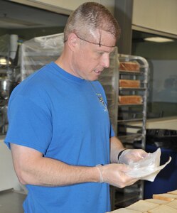 Col. Allen Duckworth, 340th Flying Training Group commander, prepares and packages sandwiches for nearly 1,000 lunches during the group’s July 12 volunteer day at the San Antonio Food Bank. Group volunteers joined others from the community to prepare the sack lunches, as well as hundreds of trays of chicken strips, for food insecure kids in the multi-county region as part of the food bank’s Million Summer Meals for Kids campaign.