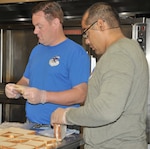 Lt. Col. Samuel Moore (blue shirt) and Tech. Sgt. Christian Delgado, from the 340th Flying Training Group headquarters, help prepare sandwiches for nearly 1,000 lunches that will be provided to food insecure children in the San Antonio multi-county region. Group members volunteered July 12 to support the San Antonio Food Bank’s Million Summer Meals for Kids campaign focused on bridging the gap during the summer months, when many kids may not have regular access to food.