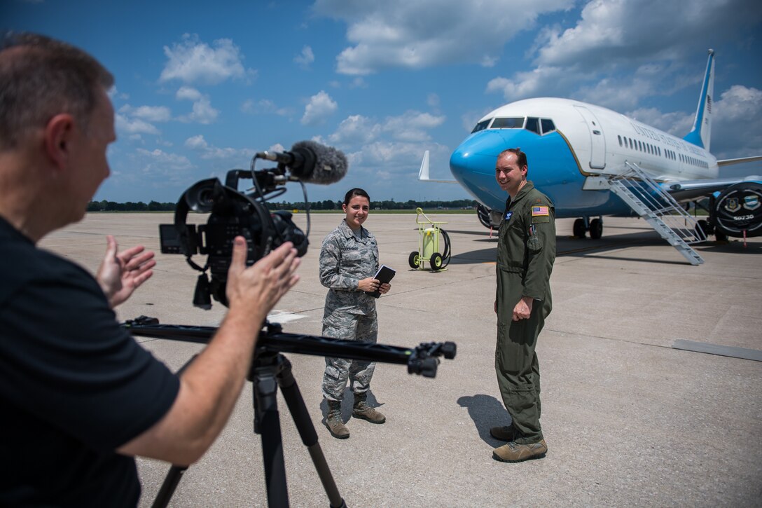 Maj. Jason Mahaffey, 73rd Airlift Squadron, right, and Senior Airman Stephanie Nakanishi, 375th Communications Squadron Mission Defense Team member, receive instructions from Thomas Jozwiak, 375th Public Affairs, video production manager, while filming a 375th Communications Group mission video July 24, 2019, at Scott Air Force Base, Illinois. The 375th MDT is a new division of the Communications Group and is working with the 932nd Operations Group and 73rd Airlift Squadron pilots to analyze improvements to cyber security with tablet devices.  (U.S. Air Force photo by Christopher Parr)
