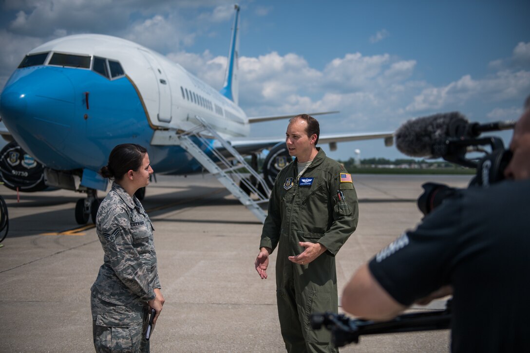 Maj. Jason Mahaffey, 73rd Airlift Squadron, right, and Senior Airman Stephanie Nakanishi, 375th Communications Squadron Mission Defense Team member, talk about how the MDT works with pilots while Thomas Jozwiak, 375th Public Affairs, video production manager, films them for a 375th Communications Group mission video July 24, 2019, at Scott Air Force Base, Illinois. The 375th MDT is a new division of the Communications Group and is working with the 932nd Operations Group  and 73rd Airlift Squadron pilots to analyze improvements to cyber security with tablet devices.  (U.S. Air Force photo by Christopher Parr)
