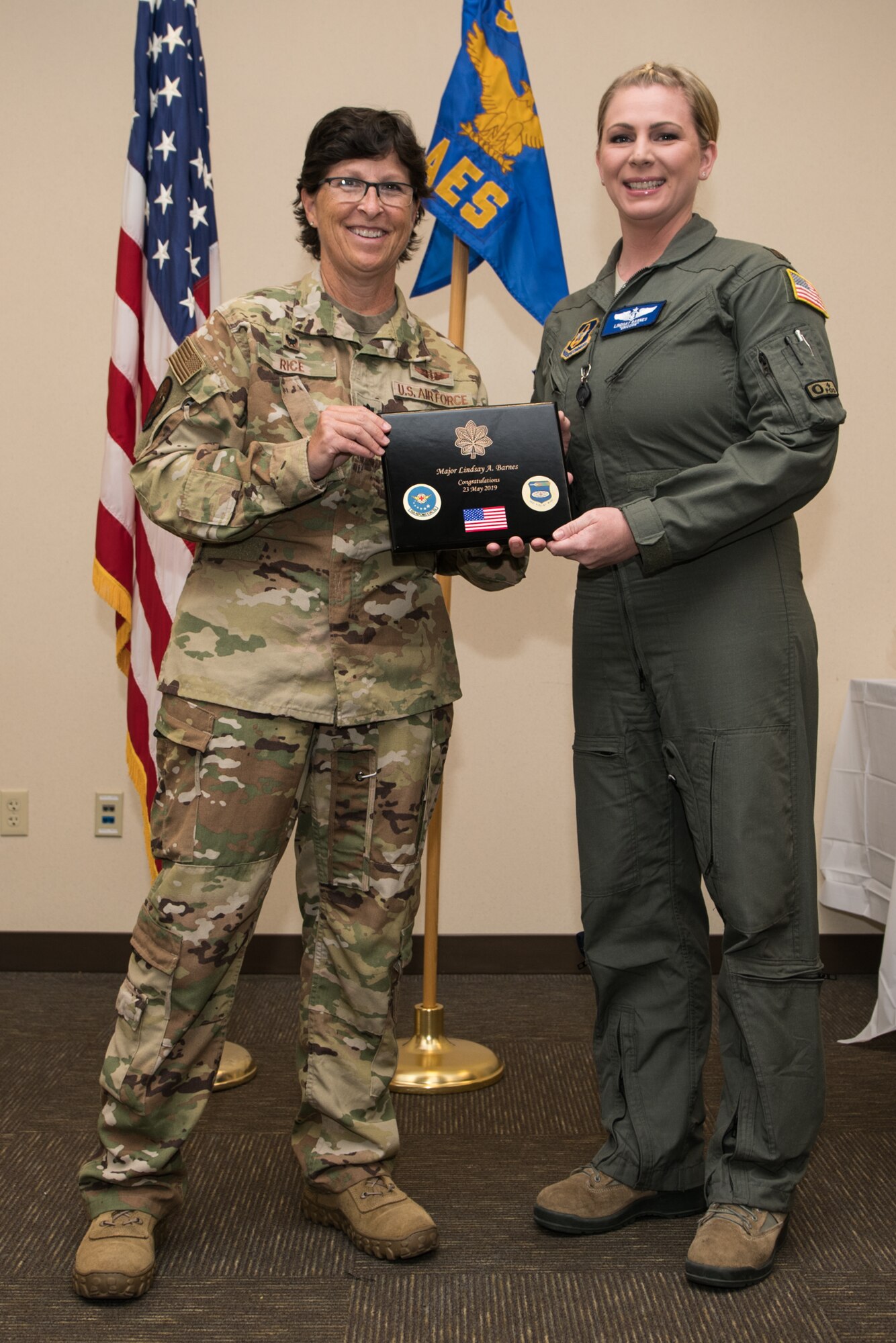 Reserve Citizen Airman Lt. Col. Dawn Rice, commander, Aeromedical Evacuation Squadron, presents Maj. Lindsay Barnes, ground training OIC, AES, a plaque during her promotion ceremony to major on August 4, 2019, Scott Air Force Base, Illinois. (U.S. Air Force photo by Senior Airman Brooke Deiters)