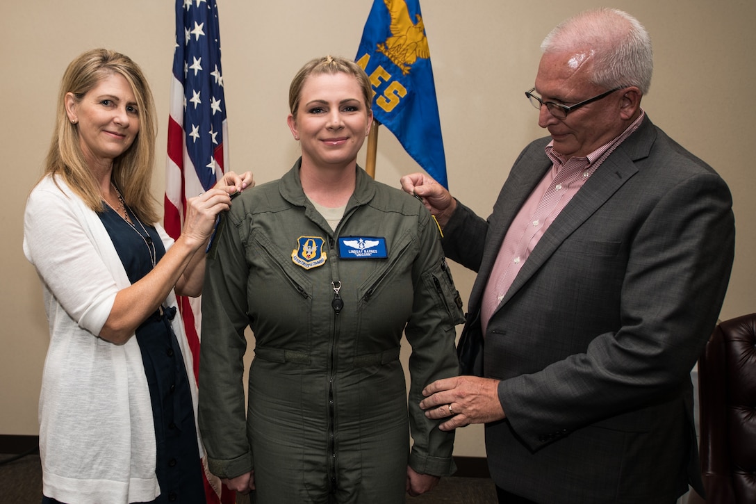 Reserve Citizen Airman  Maj. Lindsay Barnes, ground training OIC, Aeromedical Evacuation Squadron, has the rank of major pinned on by her parents on August 4, 2019, Scott Air Force Base, Illinois. (U.S. Air Force photo by Senior Airman Brooke Deiters)