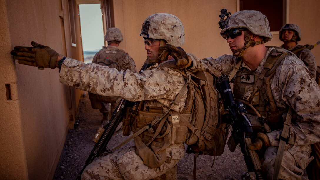 U.S. Marine Corps Lance Cpl. David Cataldo, left, and Cpl. Tyler Tobin, right, both infantry riflemen with 1st Battalion, 25th Marine Regiment, 4th Marine Division, point towards their objective during Integrated Training Exercise 5-19 at Marine Corps Air Ground Combat Center Twentynine Palms, Calif., July 31, 2019. Reserve Marines with 1/25 participate in ITX to prepare for their upcoming deployment to the Pacific Region. (U.S. Marine Corps photo by Lance Cpl. Jose Gonzalez)