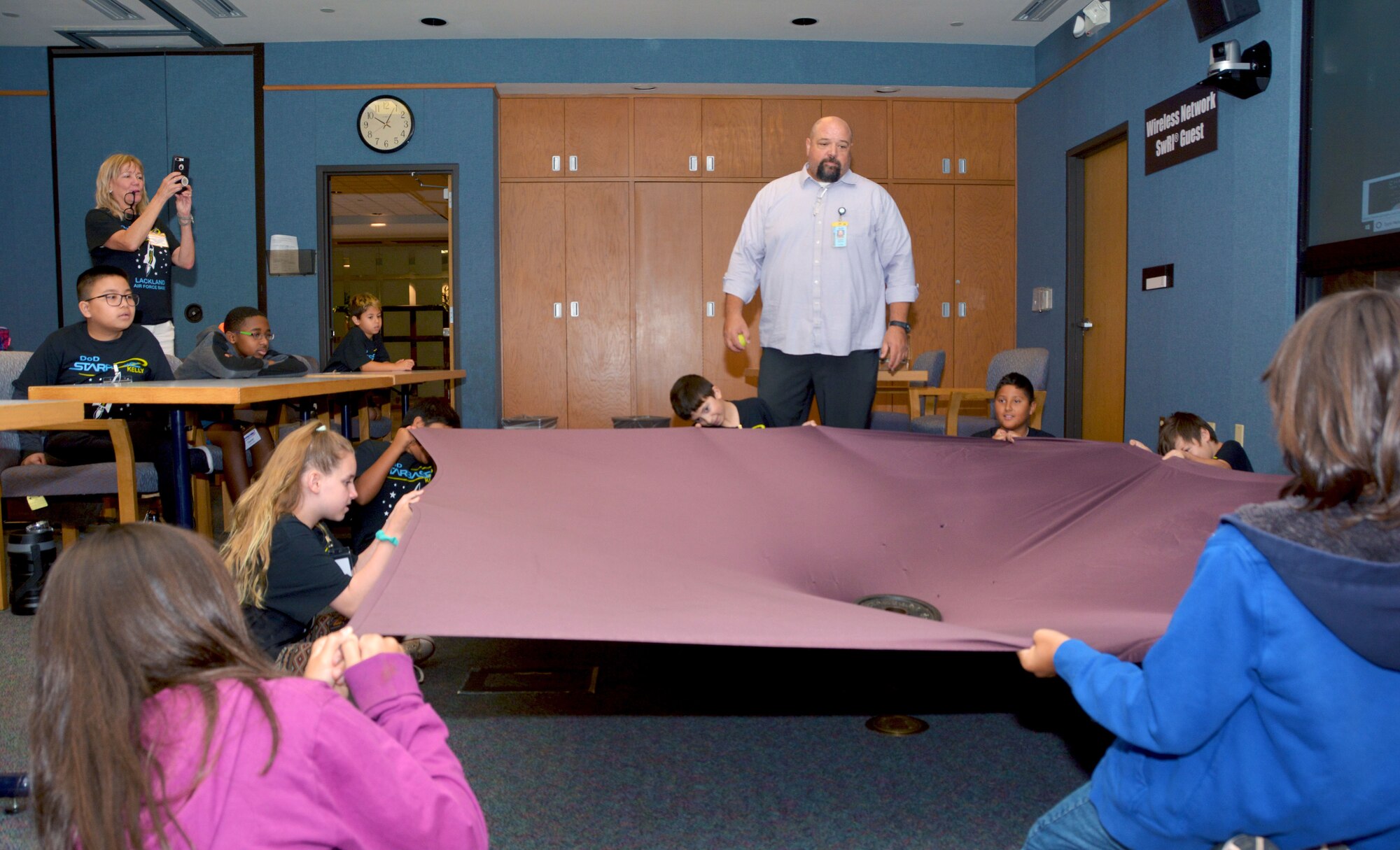 Gregory Fletcher, Southwest Research Institute Space, Science, and Engineering Division senior program manager, guides Starbase Kelly summer camp students through a gravity experiment at the Southwest Research Institute in San Antonio, Texas, July 31, 2019.