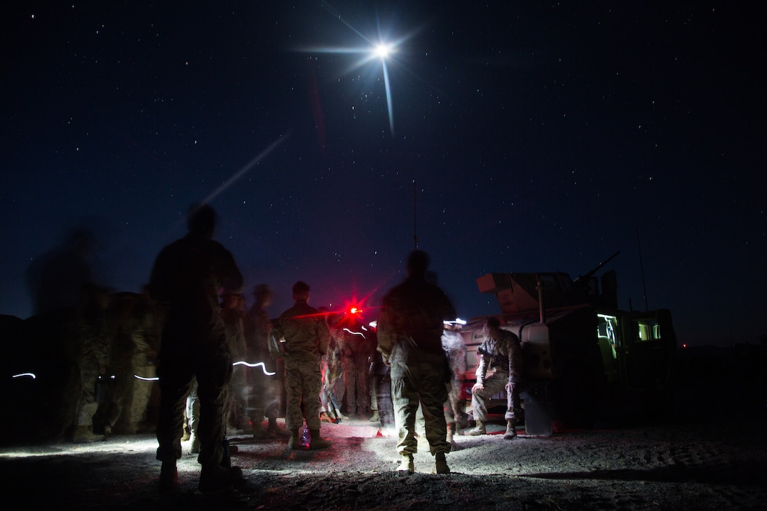 U.S. Marines and Sailors assigned to Marine Wing Support Squadron 272 prepare for an early morning brief during Integrated Training Exercise 5-19 at Marine Corps Air Ground Combat Center, Twenty-nine Palms, California, July 27, 2019. ITX 5-19 is a large-scale, combined-arms training exercise that produces combat-ready forces capable of operating as an integrated Marine Air-Ground Task Force.