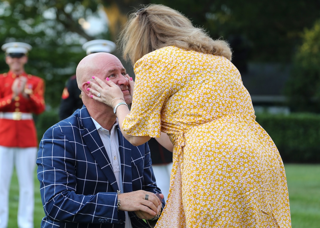 A guest of Marine Barracks Washington, D.C. proposes to his girlfriend before a Friday Evening Parade at Marine Barracks Washington, D.C., August 2, 2019. The Commandant of the Marine Corps Gen. David H. Berger was the hosting official and the Secretary of the Navy, the Honorable Richard V. Spencer, was the guest of honor for the evening. (U.S. Marine Corps photo by Cpl. James Bourgeois/Released)