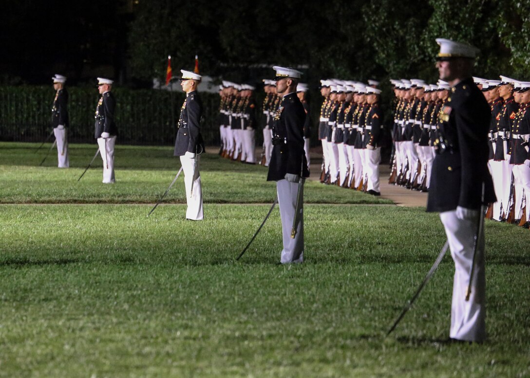Officers with Marine Barracks Washington, D.C., conduct sword manual during a Friday Evening Parade at Marine Barracks Washington, D.C., August 2, 2019. The Commandant of the Marine Corps Gen. David H. Berger was the hosting official and the Secretary of the Navy, the Honorable Richard V. Spencer, was the guest of honor for the evening. (U.S. Marine Corps photo by Cpl. James Bourgeois/Released)