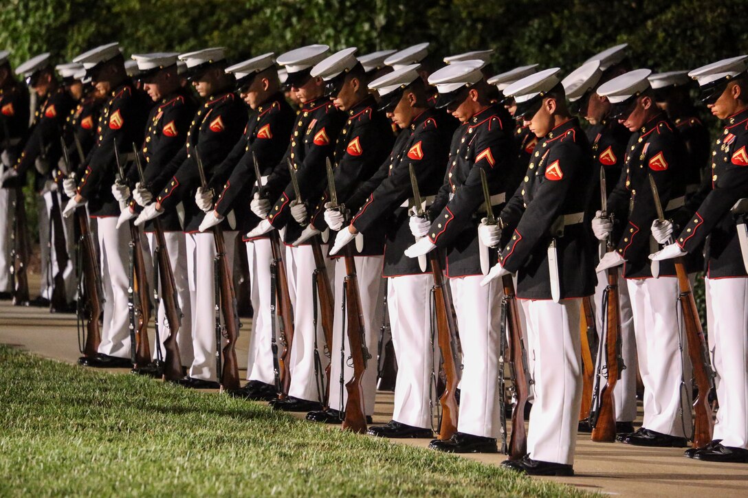 Marines with Marine Barracks Washington, D.C., conduct the “fix bayonets” sequence during a Friday Evening Parade at Marine Barracks Washington, D.C., August 2, 2019. The Commandant of the Marine Corps Gen. David H. Berger was the hosting official and the Secretary of the Navy, the Honorable Richard V. Spencer, was the guest of honor for the evening. (U.S. Marine Corps photo by Cpl. James Bourgeois/Released)