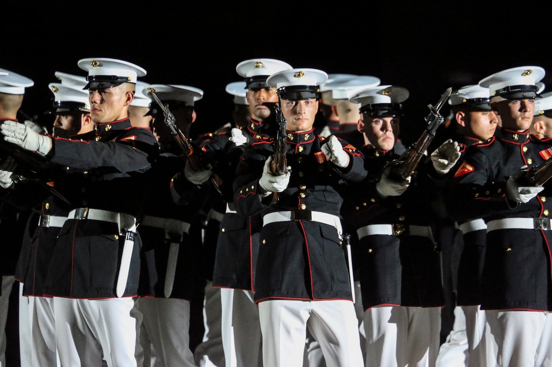 Marines with the U.S. Marine Corps Silent Drill Platoon execute their “bursting bomb” sequence during a Friday Evening Parade at Marine Barracks Washington, D.C., August 2, 2019. The Commandant of the Marine Corps Gen. David H. Berger was the hosting official and the Secretary of the Navy, the Honorable Richard V. Spencer, was the guest of honor for the evening. (U.S. Marine Corps photo by Cpl. James Bourgeois/Released)