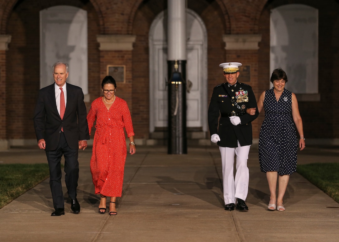 The Secretary of the Navy, the Honorable Richard V. Spencer, and the Commandant of the Marine Corps Gen. David H. Berger, accompanied by their wives, walk down center walk during a Friday Evening Parade at Marine Barracks Washington, D.C., August 2, 2019. General Berger was the hosting official and Mr. Spencer was the guest of honor for the evening. (U.S. Marine Corps photo by Sgt. Robert Knapp/Released)