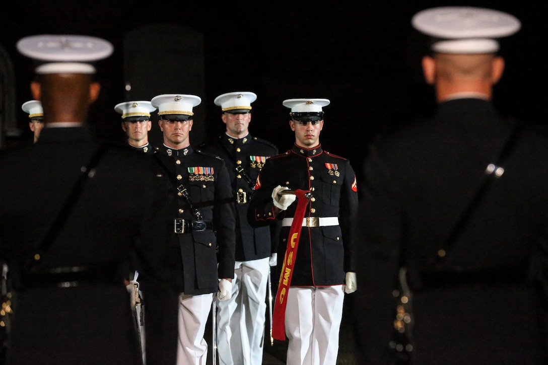 Marines with Marine Barracks Washington, D.C., stand at attention for the “officers center” sequence during a Friday Evening Parade at Marine Barracks Washington, D.C., August 2, 2019. The Commandant of the Marine Corps Gen. David H. Berger was the hosting official and the Secretary of the Navy, the Honorable Richard V. Spencer, was the guest of honor for the evening. (U.S. Marine Corps photo by Sgt. Robert Knapp/Released)