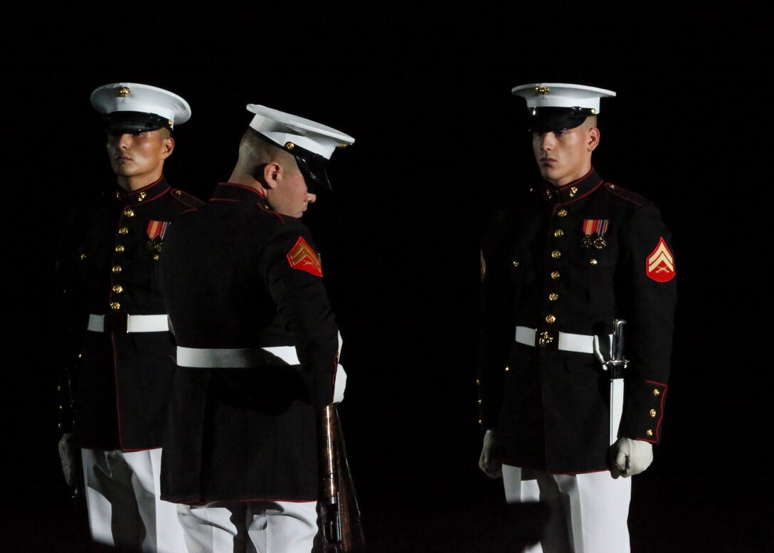 Marines with the U.S. Marine Corps Silent Drill Platoon execute their “rifle inspection” sequence during a Friday Evening Parade at Marine Barracks Washington, D.C., August 2, 2019. The Commandant of the Marine Corps Gen. David H. Berger was the hosting official and the Secretary of the Navy, the Honorable Richard V. Spencer, was the guest of honor for the evening. (U.S. Marine Corps photo by Sgt. Robert Knapp/Released)