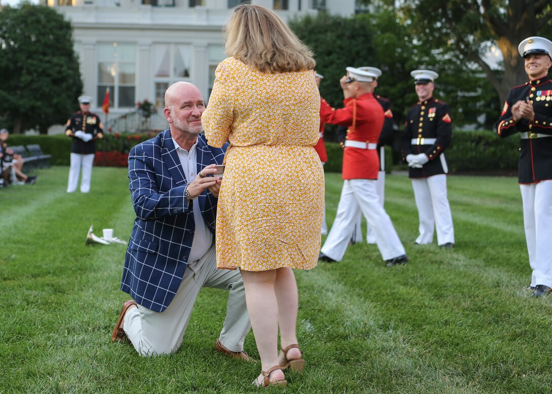 A guest of Marine Barracks Washington, D.C. proposes to his girlfriend before a Friday Evening Parade at Marine Barracks Washington, D.C., August 2, 2019. The Commandant of the Marine Corps Gen. David H. Berger was the hosting official and the Secretary of the Navy, the Honorable Richard V. Spencer, was the guest of honor for the evening. (U.S. Marine Corps photo by Cpl. James Bourgeois/Released)