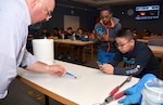 Gregory Fletcher, Southwest Research Institute Space, Science, and Engineering Division senior program manager, guides Starbase Kelly summer camp students through an experiment at the Southwest Research Institute in San Antonio July 31. The students, who are attending a camp at Joint Base San Antonio-Lackland, received instruction and demonstrations from experts in the fields of science, technology, engineering and mathematics