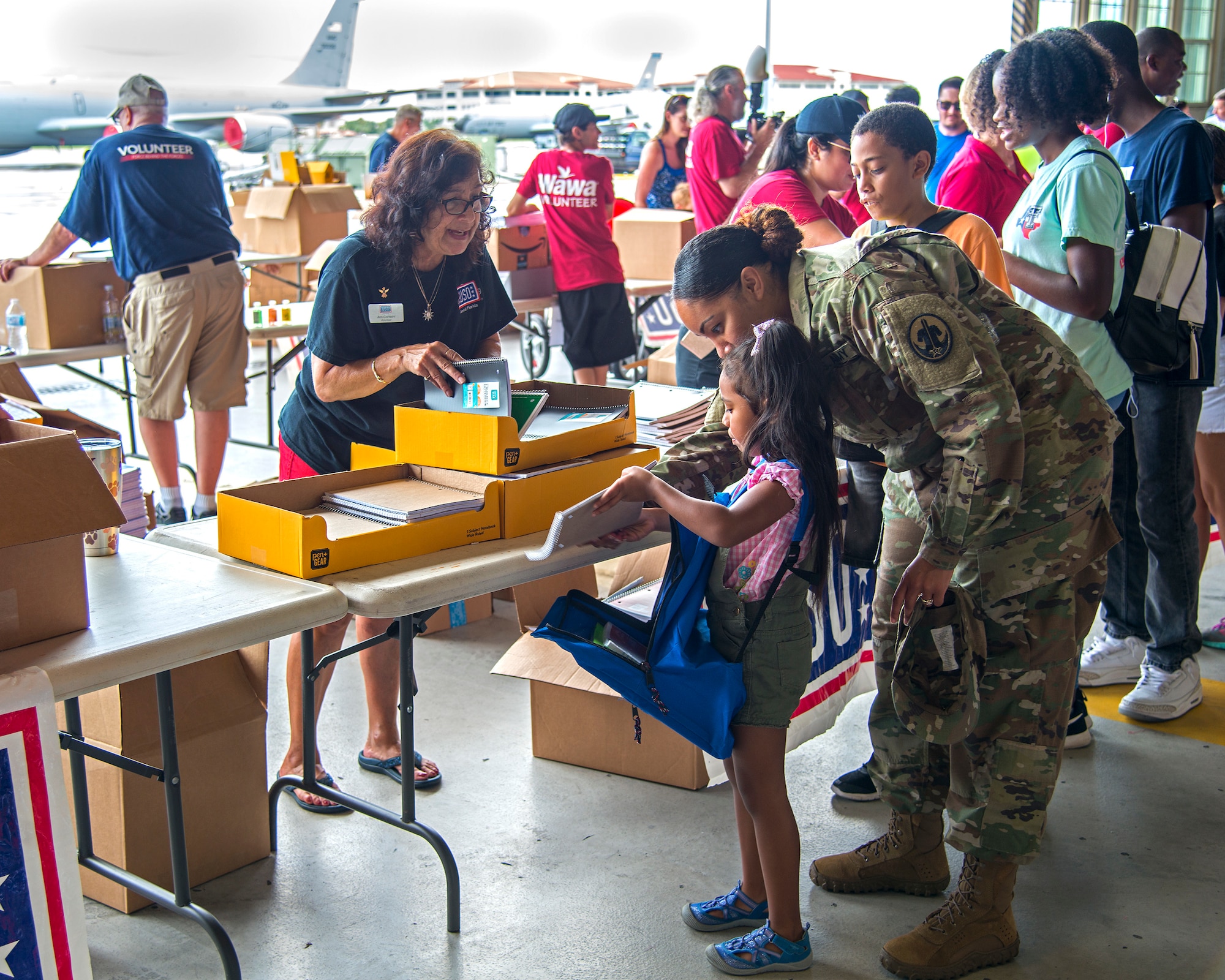 U.S. Army Sgt. 1st Class Ayla Soltren, a 5th Battalion Army Reserve Career Division counselor, collects school supplies with her daughter, Lana, at a Back to School Info Fair hosted by the 6th Force Support Squadron at MacDill Air Force Base, Fla., Aug. 3, 2019.