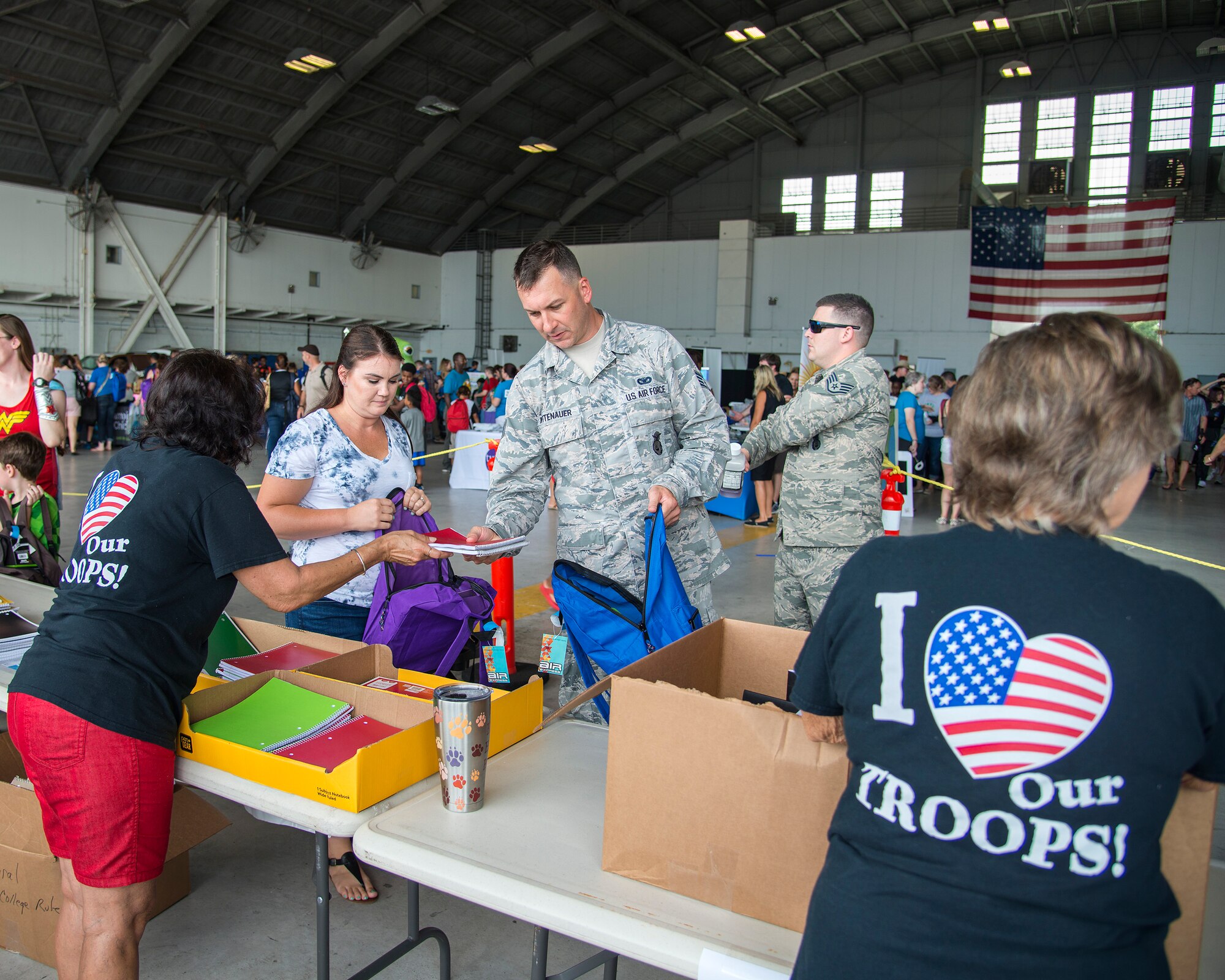 U.S. Air Force Staff Sgt. David Wittenauer, a 927th Security Forces Squadron defender, collects school supplies with his wife, Tara, at a Back to School Info Fair hosted by the 6th Force Support Squadron at MacDill Air Force Base, Fla., Aug. 3, 2019.