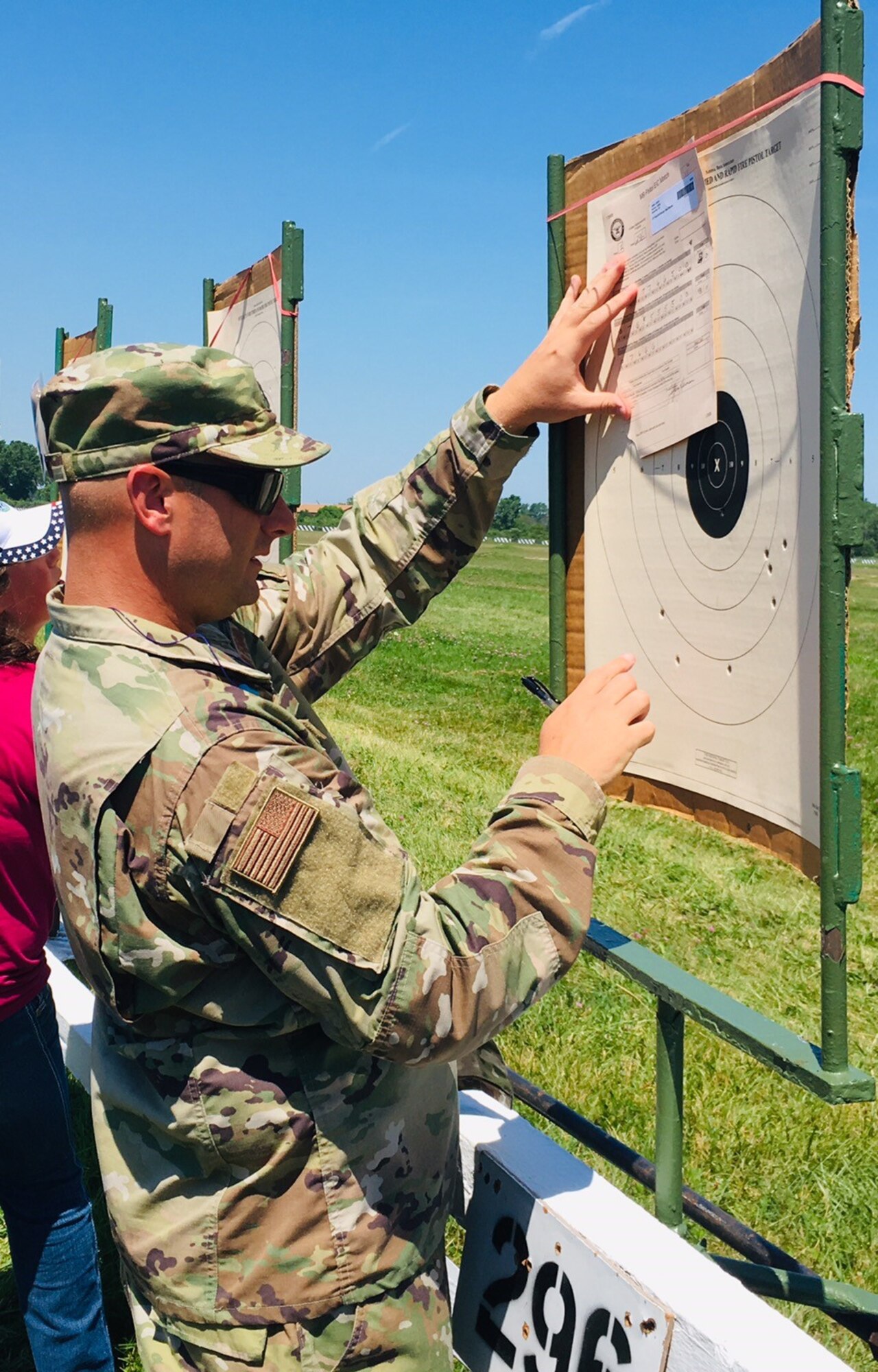 Lt. Col. Jason Harris looks at his target during the National Matches at Camp Perry, July 2019. The month-long national shooting festival hosts more than 6,000 military and civilian participants who train and compete in a variety of competition including traditional pistol, smallbore, high-power rifle and long-range rifle.
