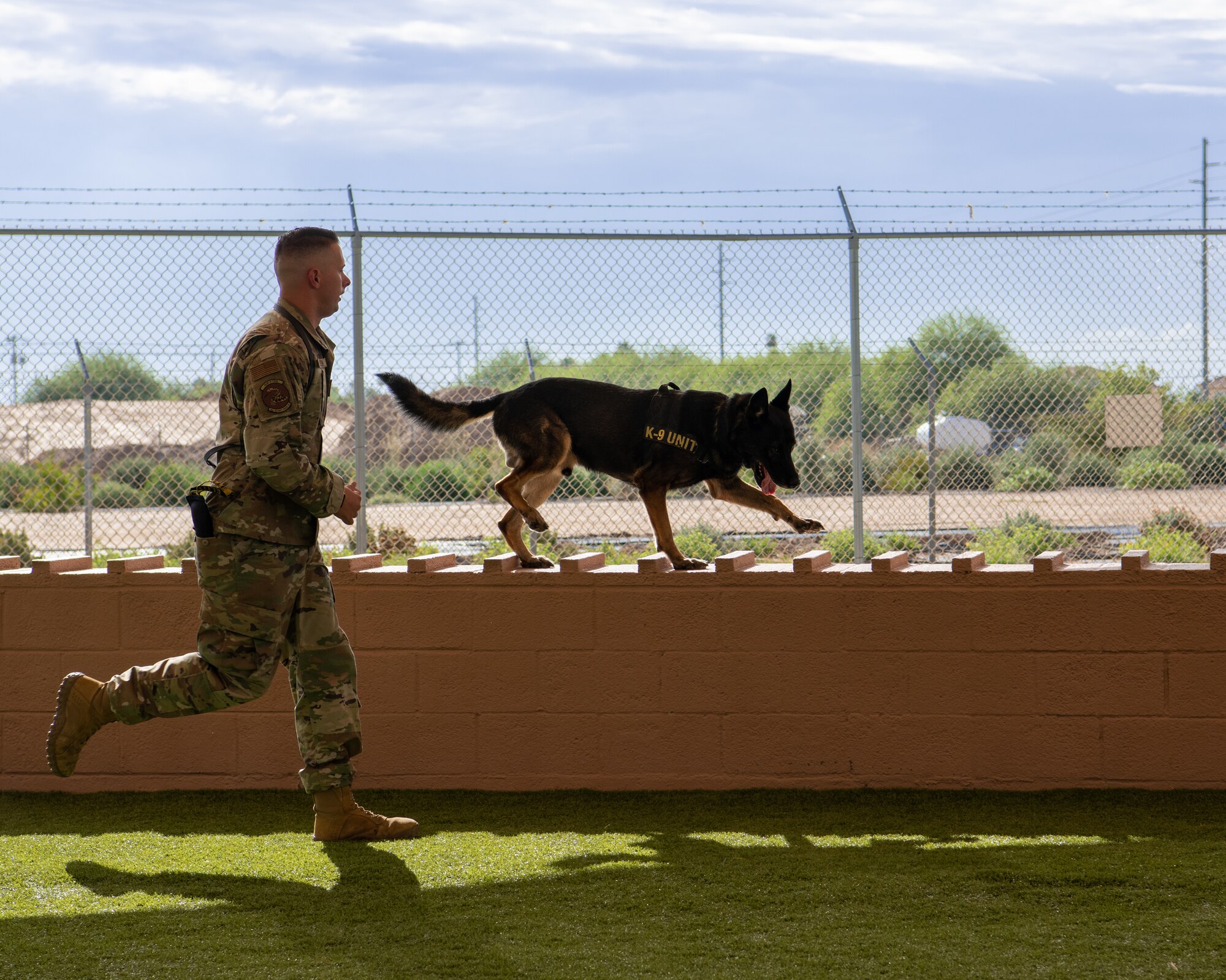 Staff. Sgt. Will Thompson, 56th Security Forces Squadron military working dog handler, runs through an obstacle course with Rango, a military working dog, July 31, 2019, at Luke Air Force Base, Ariz.
