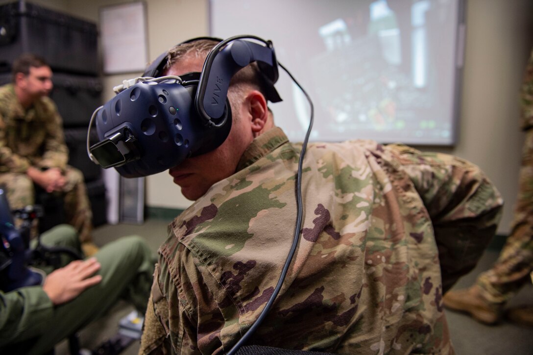 Ninth Air Force Command Chief Master Sgt. Benjamin W. Hedden, uses an HH-60G Pave Hawk virtual reality simulator (VRS) at Moody Air Force Base, Ga., July 30, 2019. The VRS is used to bridge the gap between mission concepts and flying exercises for pilots in training. (U.S. Air Force photo by Airman Azaria E. Foster)