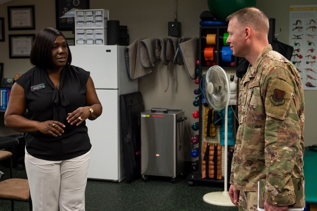 LaShayla Dyer, 41st Rescue Squadron clinical social worker, discusses the responsibilities of the Preservation of the Force and Family (POTFF) initiative with Ninth Air Force Command Chief Master Sgt. Benjamin W. Hedden, at Moody Air Force Base, Ga., July 30, 2019. The POTFF initiative strives to maintain and improve the readiness of Airmen and their families for the long-term well-being of the force. (U.S. Air Force photo by Airman Azaria E. Foster)