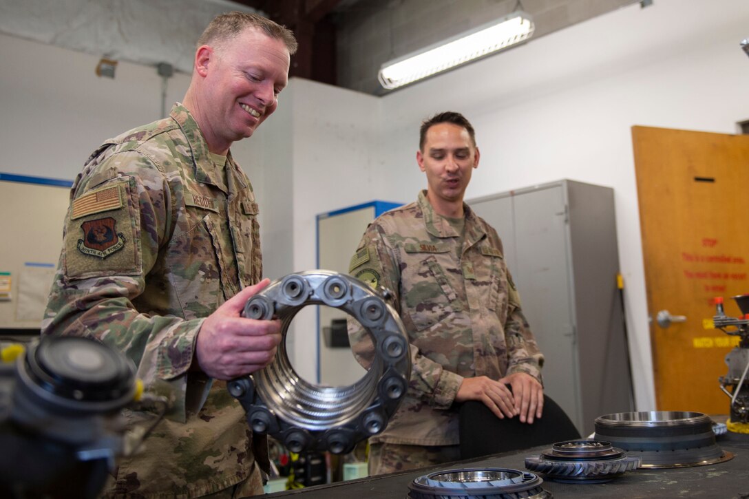 Ninth Air Force Command Chief Master Sgt. Benjamin W. Hedden, holds an engine combustion liner at Moody Air Force Base, Ga., July 30, 2019. The 41st Helicopter Maintenance Unit keeps HH-60G Pave Hawk’s operationally ready by performing inspections and repairs on various components of the helicopter. (U.S. Air Force photo by Airman Azaria E. Foster)
