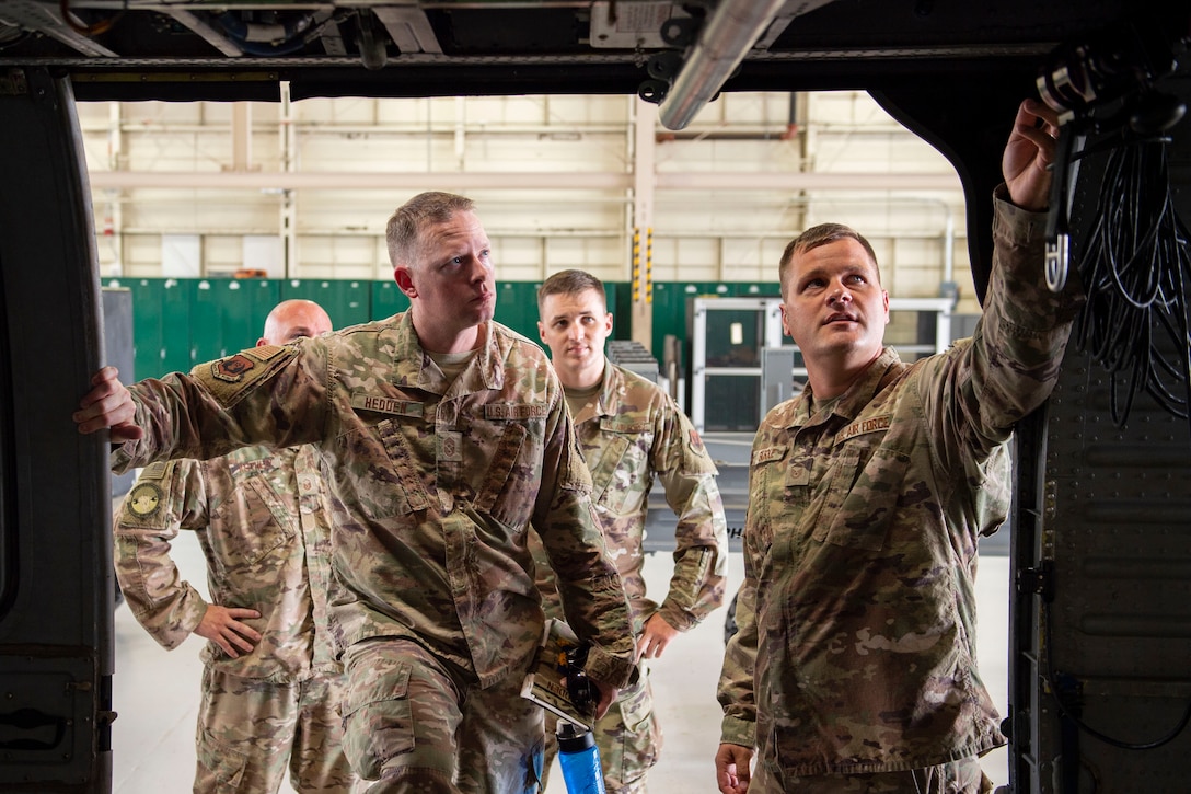 Airman 1st Class Nathaniel Fuentes, right, 723d Aircraft Maintenance Squadron (AMXS) weapons load crew member, explains how to fire a GAU-18/A to Ninth Air Force Command Chief Master Sgt. Benjamin W. Hedden, at Moody Air Force Base, Ga., July 30, 2019. The 723d AMXS is responsible for generating, mobilizing, deploying and employing forces to provide combat and peacetime search and rescue operations in support of U.S. national security interests. (U.S. Air Force photo by Airman Azaria E. Foster)