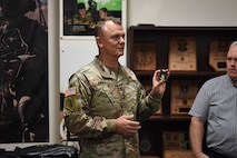 Gen. Paul Funk II, commanding general of U.S. Army Training and Doctrine Command, discusses the personal presentation items produced by the U.S. Army Marketing Engagement Brigade during a visit to the brigade headquarters at Fort Knox, Kentucky, Aug. 1. The MEB's mission is to support Army accessions. The unit does a variety of support operations, one being the production of presentation items for both U.S. Army Recruiting Command and U.S. Army Cadet Command. This was Funk's first visit to the brigade since taking command of TRADOC. (U.S. Army photo by Lara Poirrier)