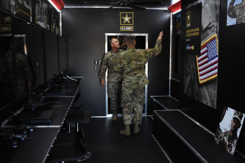 Gen. Paul Funk II, commanding general of U.S. Army Training and Doctrine Command, receives a tour of the mobile recruiting trailer during his visit to the Marketing Engagement Brigade headquarters at Fort Knox, Kentucky, Aug. 1. The mobile recruiting trailer is just one of the mobile army exhibits the Mobile Exhibit Company, Mission Support Battalion, deploys around the country to support recruiting operations. (U.S. Army photo by Lara Poirrier)