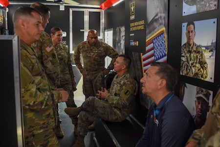 Gen. Paul Funk II, commanding general of U.S. Army Training and Doctrine Command, and Medal of Honor Recipient Staff Sgt. David Bellavia talk with the command team of the U.S. Army Marketing Engagement Brigade Col. Megan Stallings and Command Sgt. Maj. Steven Laick during a tour of the brigade headquarters at Fort Knox, Kentucky, Aug.1. (U.S. Army photo by Lara Poirrier)