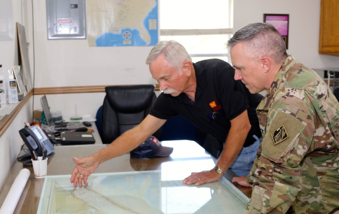 MATAGORDA, Texas (July 30, 2019) Robert George, Colorado River Locks lockmaster, discusses the importance of the navigational mission with Galveston District commander Col. Timothy Vail, during one of the commander's project visits. The Gulf Intracoastal Waterway in Texas is 423 miles long and has two sets of floodgates at the intersection of the Brazos River (Brazos River East and West Floodgates) and two locks where it intersects the Colorado River. 

(U.S. Army Corps of Engineers Photo by Francisco G. Hamm)