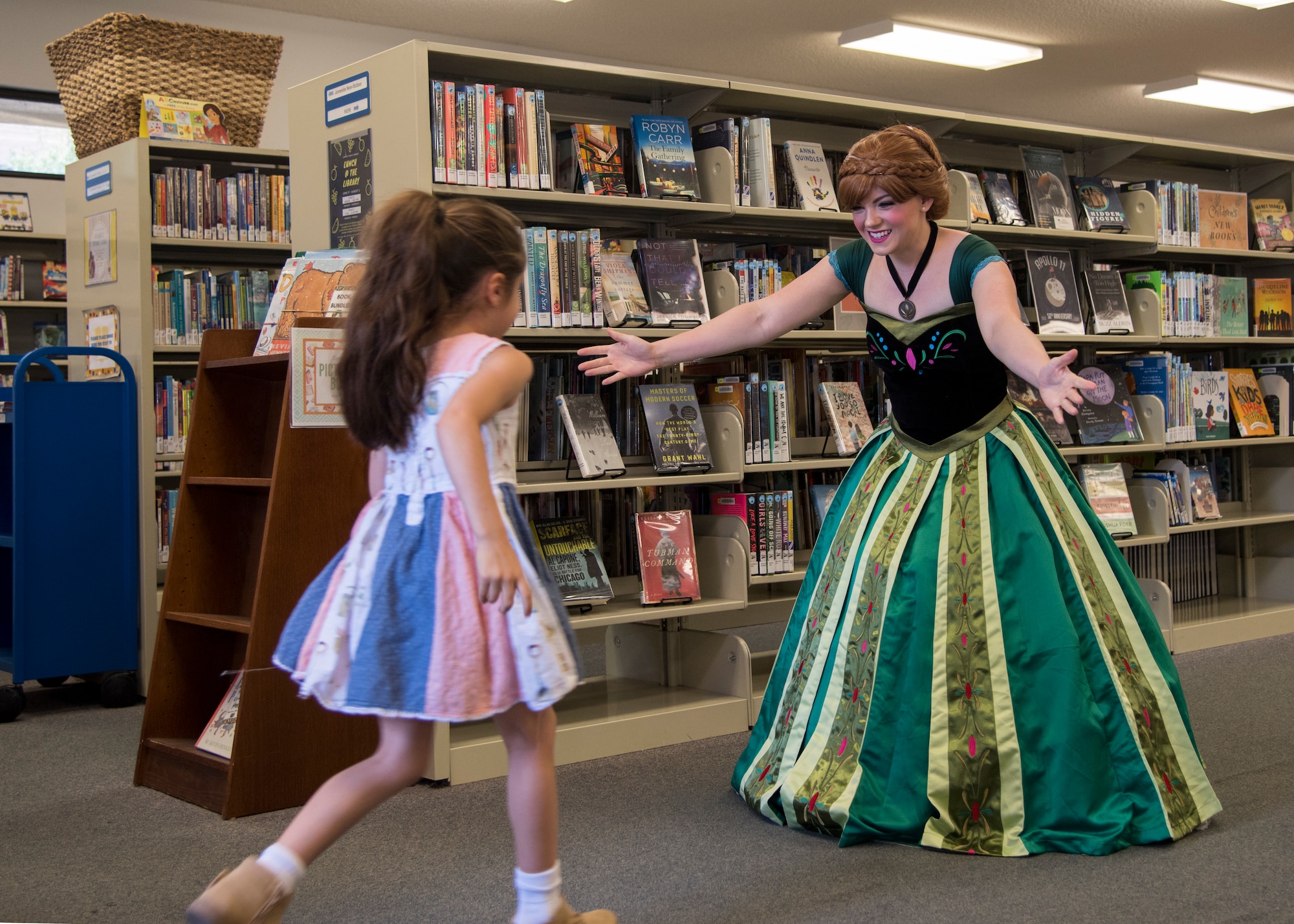Staff Sgt. Erica Darcy, 614th Air Operation Center intelligence analyst, welcomes a child during a children’s book reading at a local library June 24, 2019, in Vandenberg Village, Calif.