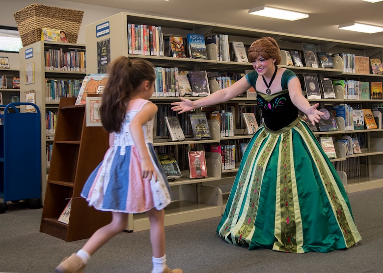 Staff Sgt. Erica Darcy, 614th Air Operation Center intelligence analyst, welcomes a child during a children’s book reading at a local library June 24, 2019, in Vandenberg Village, Calif.