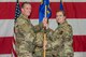 U.S. Air Force Col. Matthew Powell, 354th Maintenance Group commander, hands the 354th Aircraft Maintenance Squadron guidon to U.S. Air Force Maj. Kathryn Damron the 354th AMXS commander, at Eielson Air Force Base, Alaska, Aug. 1, 2019.