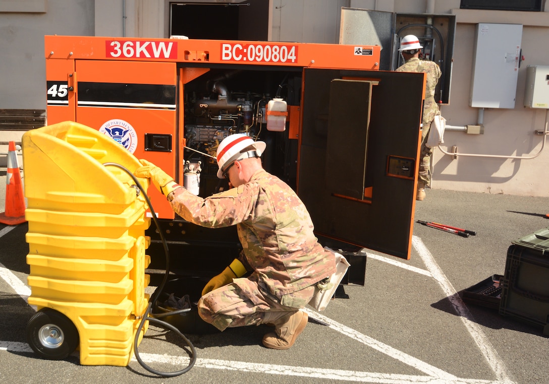 As a culmination of months of training and preparation, the 249th Engineer Battalion (Alpha Company) 3rd Power Station Prime Power Specialist Staff Sgt. Jason Pallack and his partner Pfc. Jason D. Pallack conduct a simulated power outage June 21.