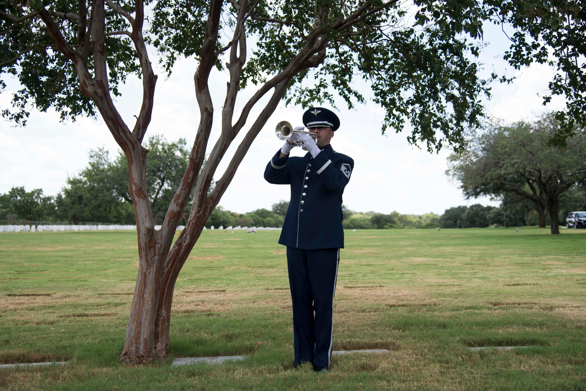 A U.S. Air Force Honor Guard Airman plays "Taps" during the funeral ceremony of Oliver "Ollie" Crawford Aug. 5, 2019, at Joint Base San Antonio-Fort Sam Houston, Texas. "Ollie" passed away at the age of 94, on Sunday, July 21, 2019 in San Antonio, Texas.