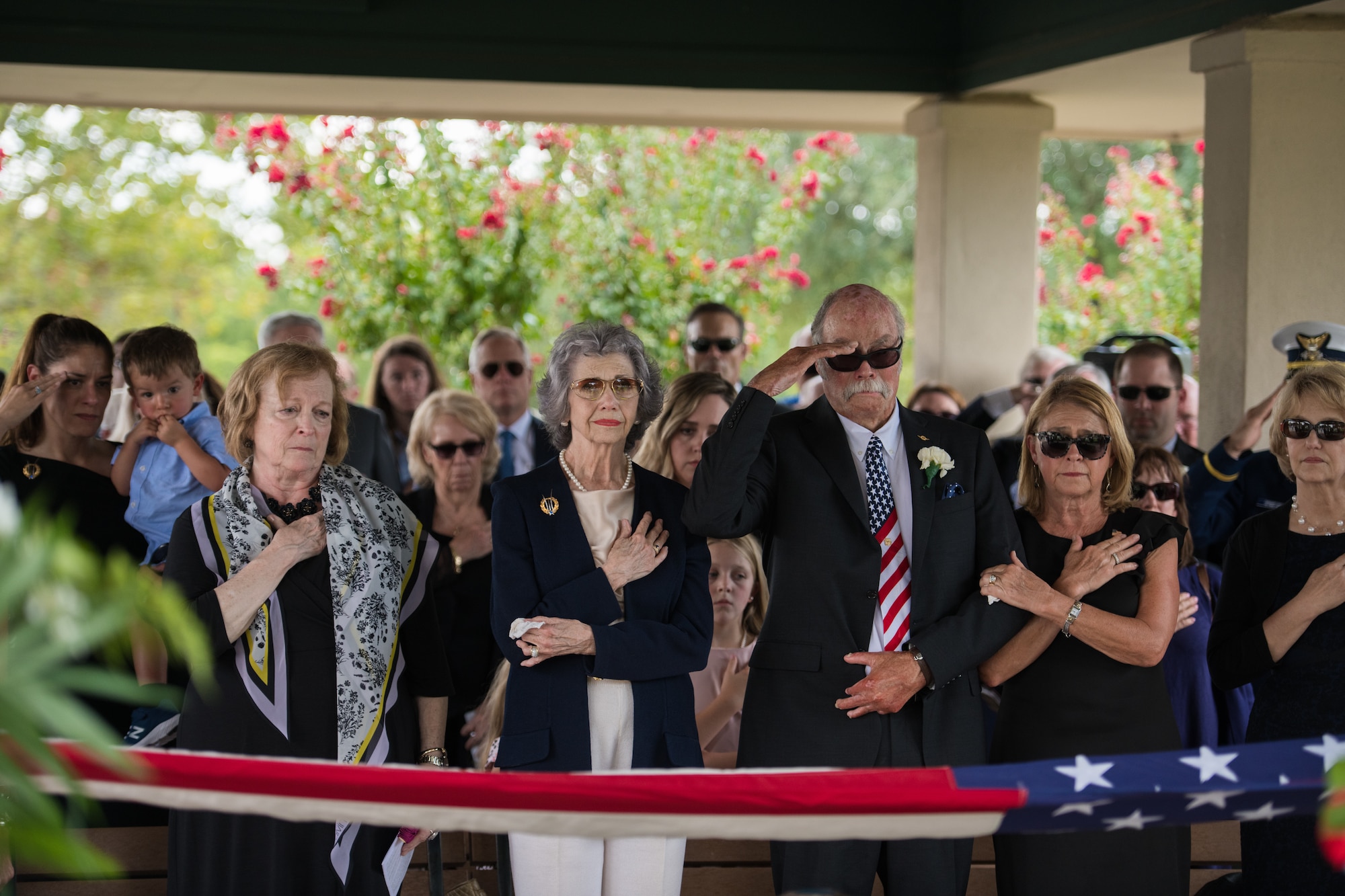 Nancy (center), surviving wife of Oliver "Ollie" Crawford, places her hand over heart during her husband's funeral ceremony Aug. 5, 2019, at Joint Base San Antonio-Fort Sam Houston, Texas. "Ollie" passed away at the age of 94, on Sunday, July 21, 2019 in San Antonio, Texas.