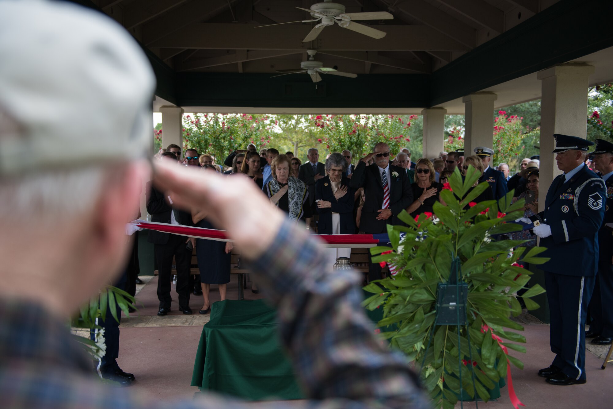 Nancy (center), surviving wife of Oliver "Ollie" Crawford, places her hand over heart during her husband's funeral ceremony Aug. 5, 2019, at Joint Base San Antonio-Fort Sam Houston, Texas. "Ollie" passed away at the age of 94, on Sunday, July 21, 2019 in San Antonio, Texas.